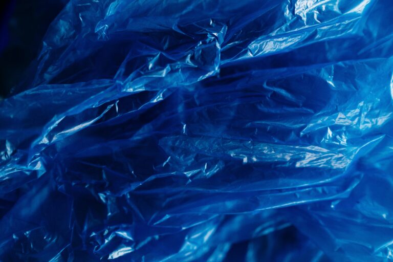 A vibrant close-up of crumpled blue plastic showcasing texture and recyclability.
